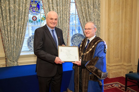 Christopher Horton, Director of Operations for Novus (left), collects the Eric Hill Award from Philip Morrish, Master of the Worshipful Company of Environmental Cleaners (right).